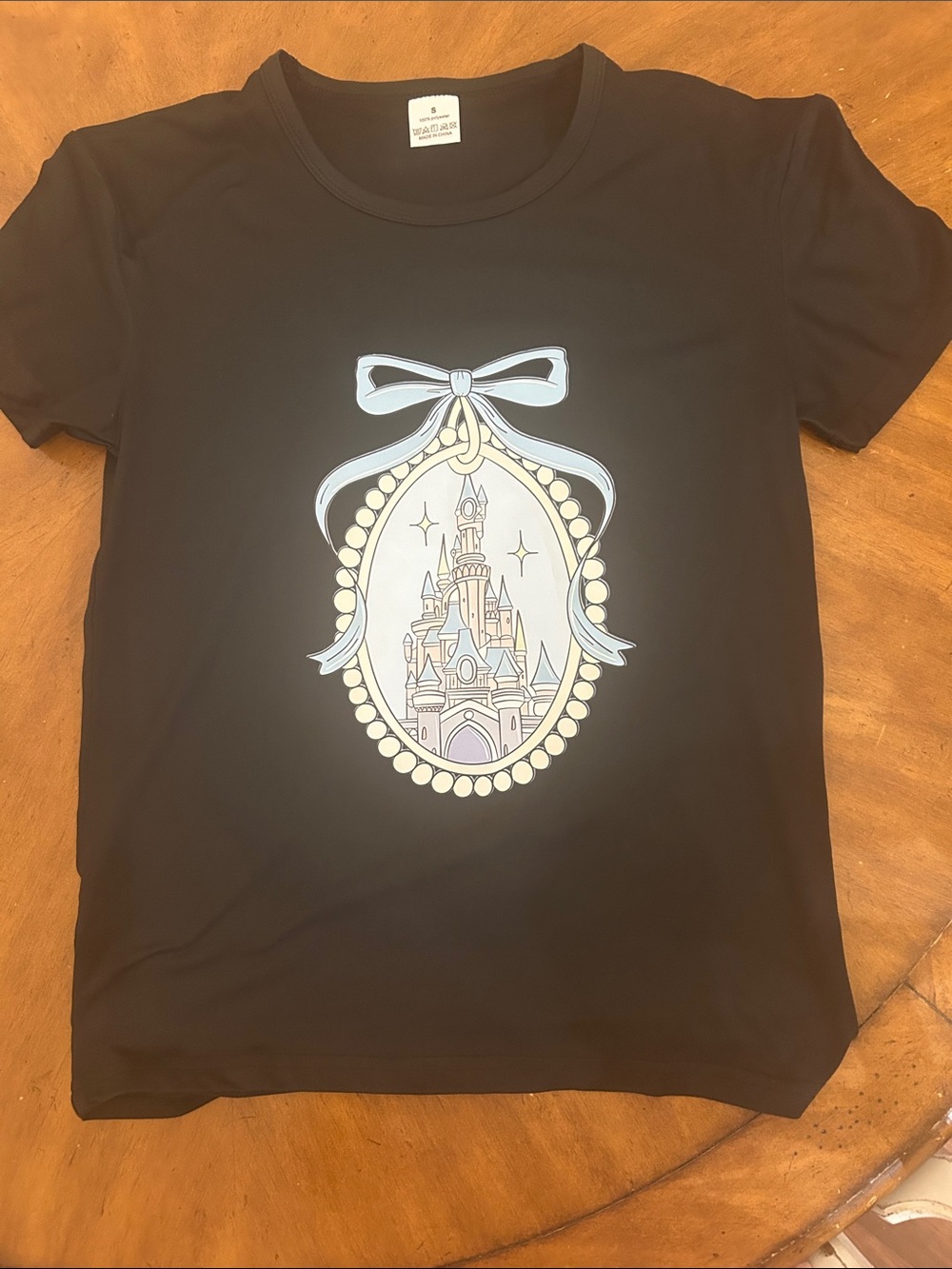 Black Short-Sleeve Tee with Pastel Castle Medallion Graphic